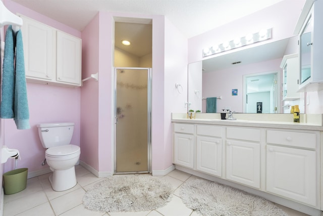 bathroom with tile patterned flooring, vanity, toilet, and a shower with shower door