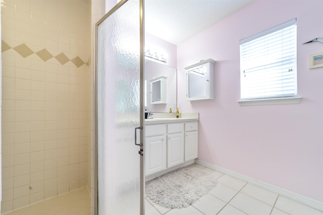 bathroom featuring tile patterned flooring, an enclosed shower, vanity, and a textured ceiling