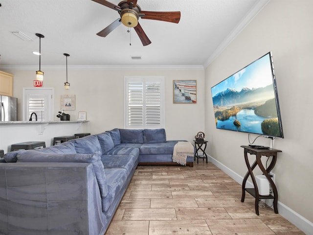 living room featuring ceiling fan and crown molding