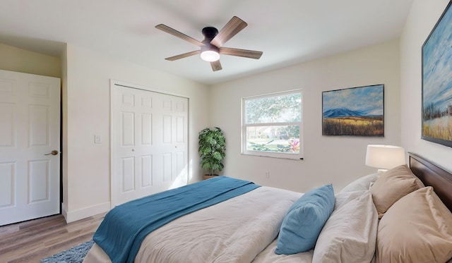 bedroom featuring a closet, light hardwood / wood-style flooring, and ceiling fan