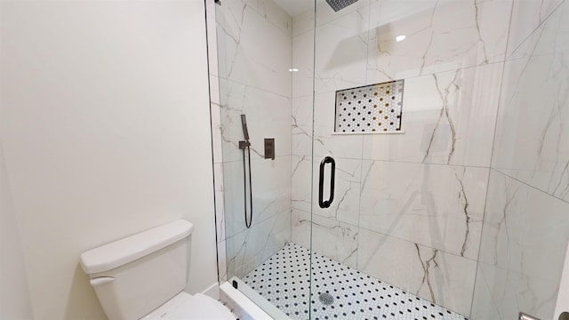 bathroom with an enclosed shower and toilet