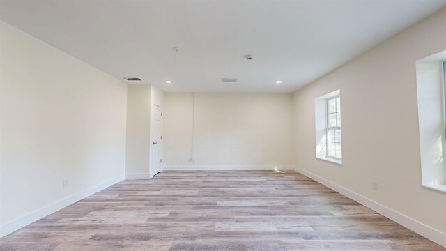 empty room with light hardwood / wood-style floors