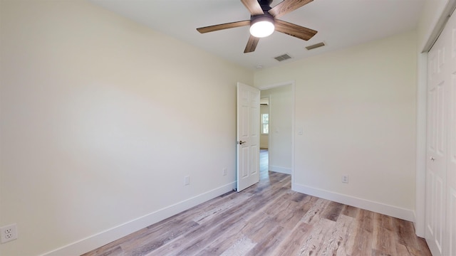 unfurnished bedroom featuring ceiling fan, a closet, and light hardwood / wood-style floors