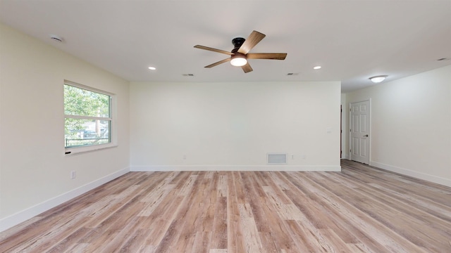 spare room with ceiling fan and light wood-type flooring