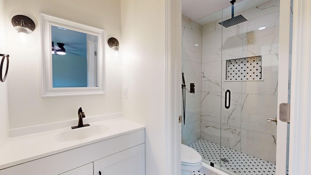 bathroom with vanity, toilet, and a shower with door