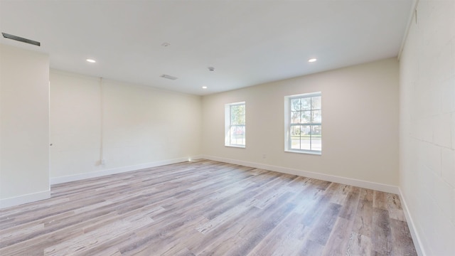 empty room with light hardwood / wood-style flooring