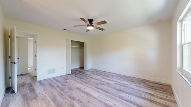 unfurnished bedroom featuring ceiling fan, a closet, and light hardwood / wood-style floors