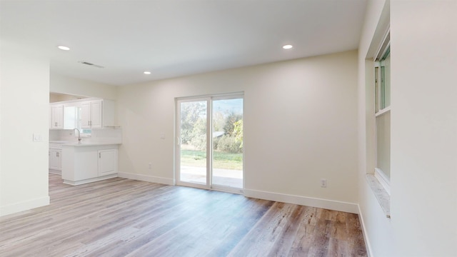 unfurnished living room with light hardwood / wood-style flooring