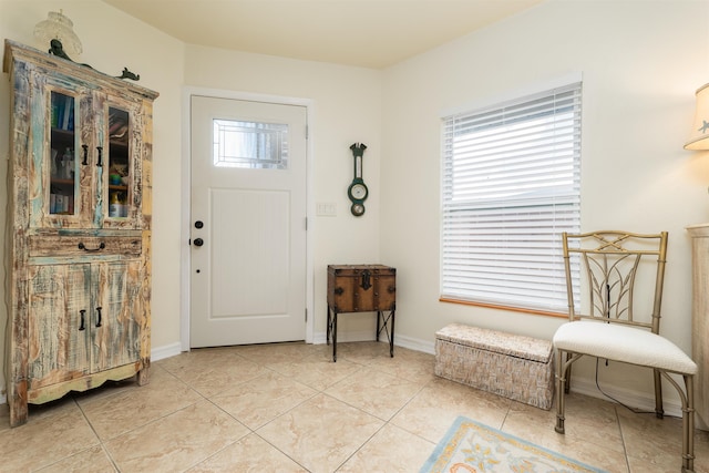 foyer with light tile patterned floors and a wealth of natural light