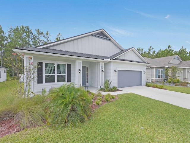 view of front of home with a front lawn and a garage