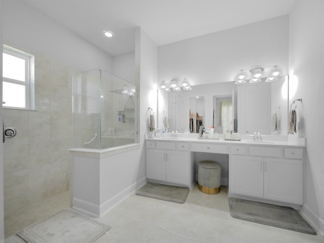 bathroom featuring tiled shower, vanity, and tile patterned floors