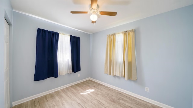 5015 Portsmouth Ave, Jacksonville, FL 32208 - spare room featuring baseboards, ceiling fan, and wood finished floors