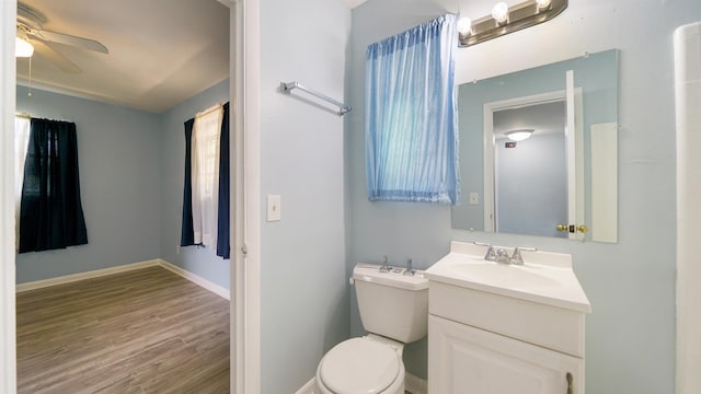 5015 Portsmouth Ave, Jacksonville, FL 32208 - bathroom featuring baseboards, toilet, a ceiling fan, vanity, and wood finished floors