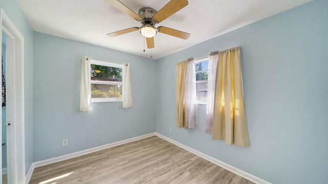 5015 Portsmouth Ave, Jacksonville, FL 32208 - unfurnished room with plenty of natural light, ceiling fan, baseboards, and wood finished floors