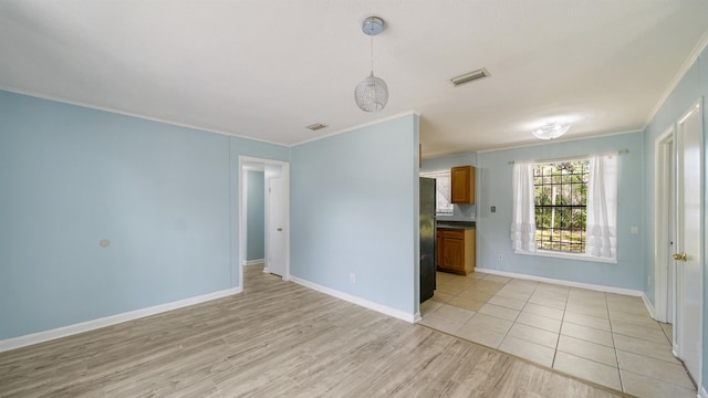 5015 Portsmouth Ave, Jacksonville, FL 32208 - unfurnished living room featuring light wood-style floors, visible vents, baseboards, and ornamental molding