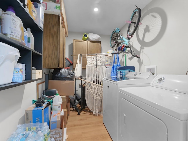 laundry area featuring light hardwood / wood-style flooring and washer and dryer