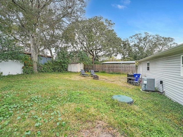 view of yard with cooling unit and a shed