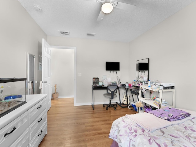 bedroom featuring a textured ceiling, ceiling fan, and light hardwood / wood-style flooring