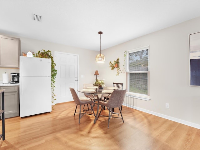 dining space with light hardwood / wood-style flooring