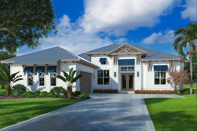 3 Ranshire Ln, Palm Coast, FL 32164 - view of front of home featuring french doors, a garage, a standing seam roof, a front yard, and concrete driveway