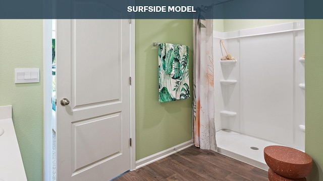 bathroom featuring curtained shower and hardwood / wood-style floors