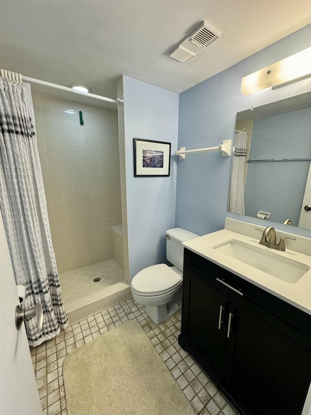 390 A1A Beach Blvd Unit 49, Saint Augustine Beach, FL 32080 - bathroom featuring a tile shower, toilet, and vanity