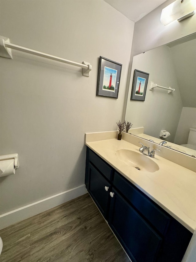 390 A1A Beach Blvd Unit 49, Saint Augustine Beach, FL 32080 - half bath with toilet, wood finished floors, vanity, and baseboards