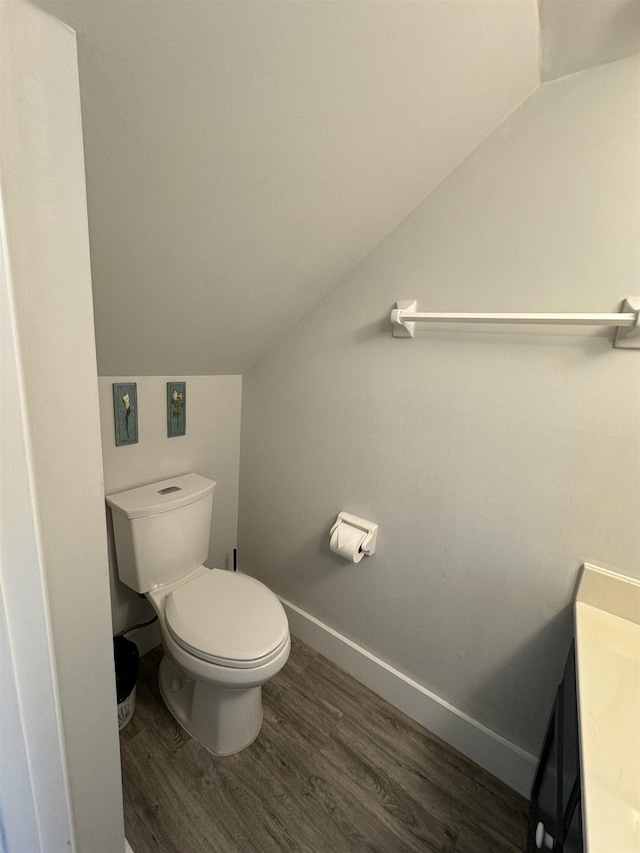 390 A1A Beach Blvd Unit 49, Saint Augustine Beach, FL 32080 - bathroom featuring lofted ceiling, wood finished floors, toilet, baseboards, and vanity