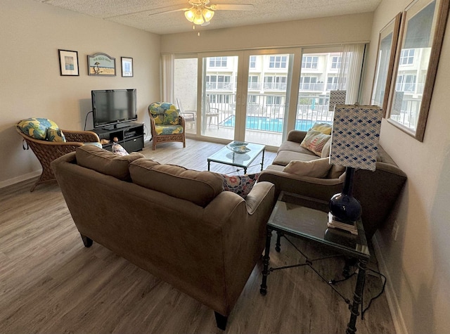 390 A1A Beach Blvd Unit 49, Saint Augustine Beach, FL 32080 - living room featuring wood finished floors, ceiling fan, baseboards, and a textured ceiling