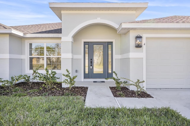 view of exterior entry with a garage