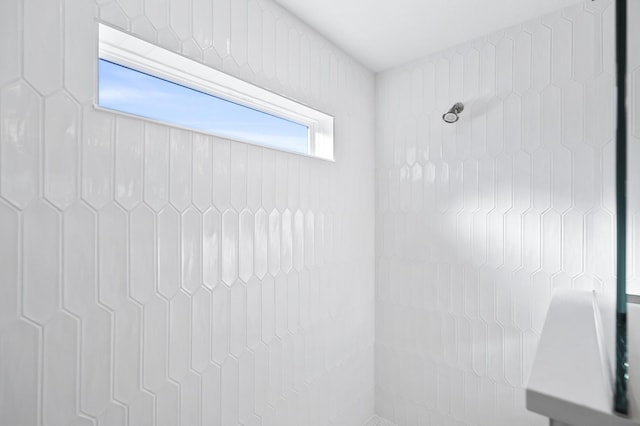 bathroom with tiled shower