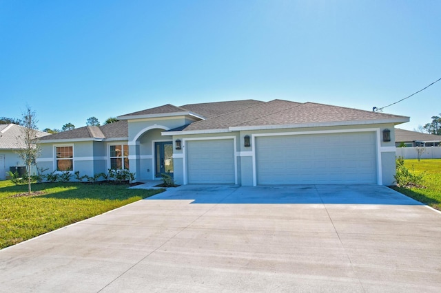 single story home with a front yard and a garage