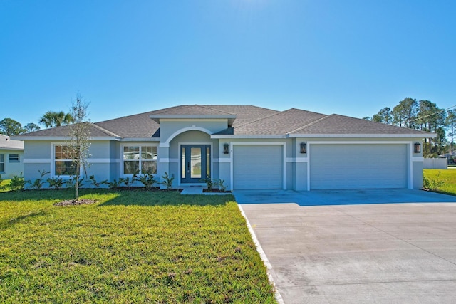 view of front of home featuring a front yard and a garage