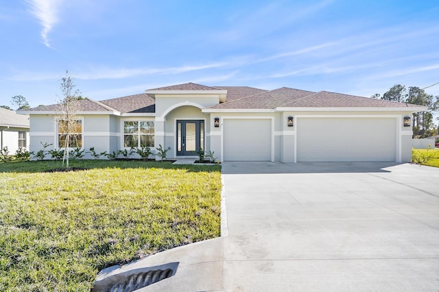 view of front of home featuring a front yard and a garage