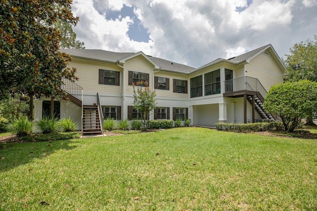 104 Laurel Wood Way Unit 202, Saint Augustine, FL 32086 - back of property with stairs, a yard, a sunroom, and stucco siding