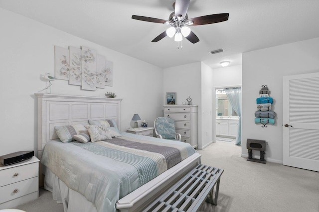 104 Laurel Wood Way Unit 202, Saint Augustine, FL 32086 - bedroom with light carpet, ensuite bath, and a ceiling fan