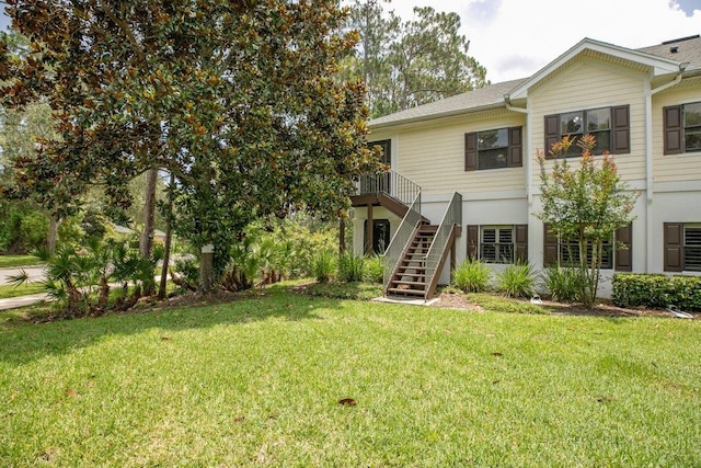 104 Laurel Wood Way Unit 202, Saint Augustine, FL 32086 - view of front of house with stairs, a front lawn, and a wooden deck