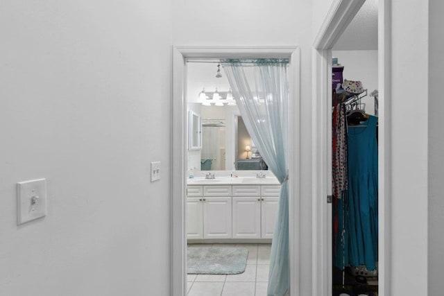 104 Laurel Wood Way Unit 202, Saint Augustine, FL 32086 - bathroom featuring tile patterned flooring, double vanity, a walk in closet, and a chandelier