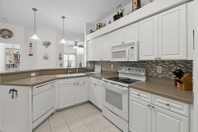 104 Laurel Wood Way Unit 202, Saint Augustine, FL 32086 - kitchen with white appliances, a ceiling fan, light tile patterned floors, a peninsula, and white cabinets