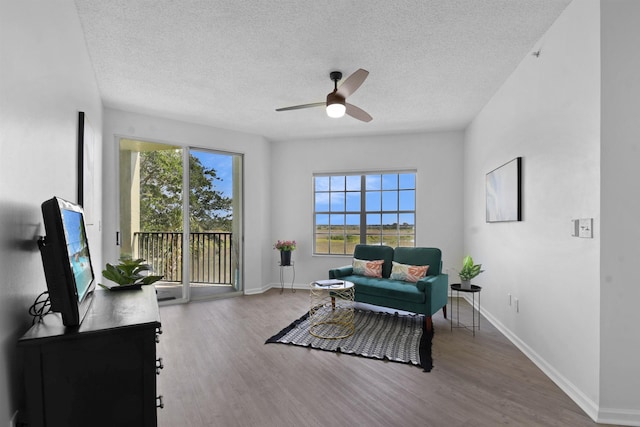 4020 Grande Vista Blvd Unit 204, Saint Augustine, FL 32084 - sitting room with a ceiling fan, wood finished floors, a textured ceiling, and baseboards
