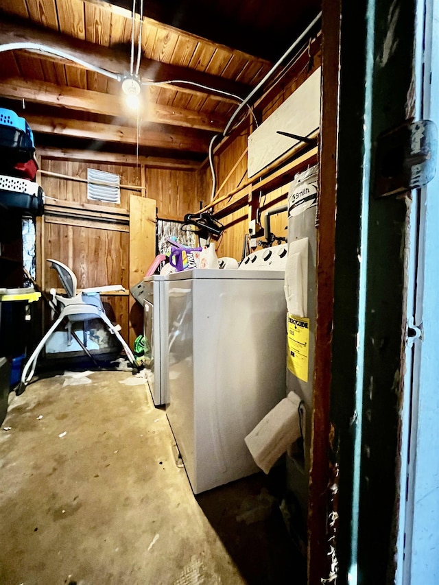 basement with washer and clothes dryer, wood walls, and wood ceiling