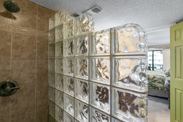 4670 A1A S Unit 1309, Saint Augustine, FL 32080 - interior details with a textured ceiling, ensuite bath, and a walk in shower