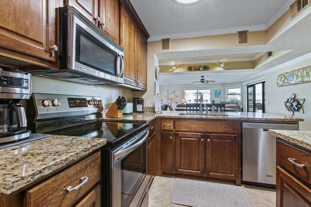 4670 A1A S Unit 1309, Saint Augustine, FL 32080 - kitchen featuring ceiling fan, a sink, ornamental molding, and appliances with stainless steel finishes