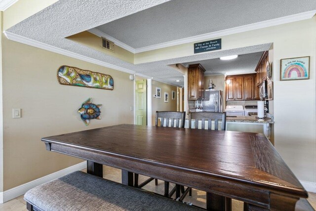 4670 A1A S Unit 1309, Saint Augustine, FL 32080 - dining space with ornamental molding, baseboards, and a textured ceiling