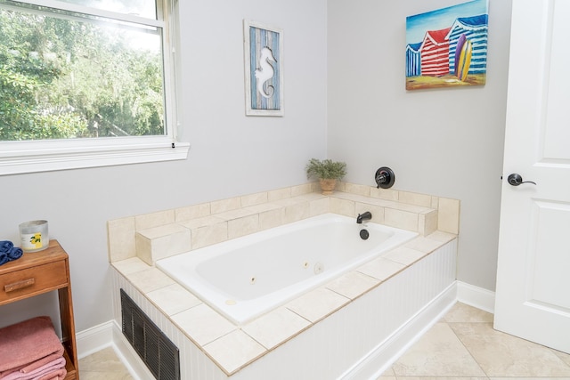 bathroom featuring tile patterned floors and a relaxing tiled tub