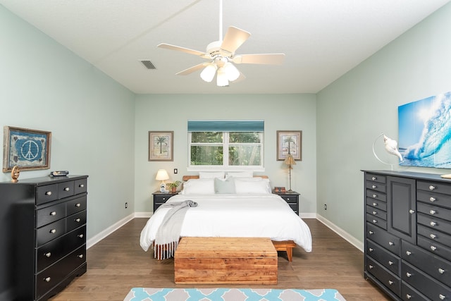 bedroom with ceiling fan and dark hardwood / wood-style floors