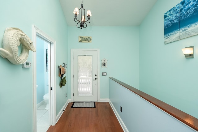 doorway featuring light hardwood / wood-style floors and an inviting chandelier