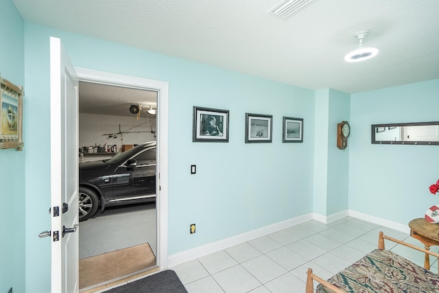 interior space with light tile patterned floors and a textured ceiling