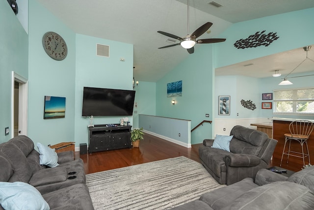 living room with ceiling fan, high vaulted ceiling, and dark hardwood / wood-style floors