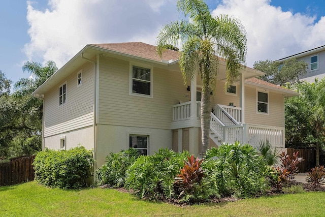 rear view of property with a yard